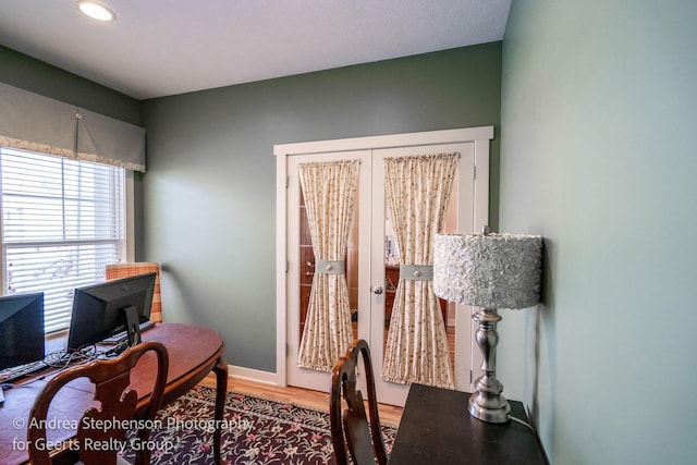 home office featuring baseboards, wood finished floors, and french doors