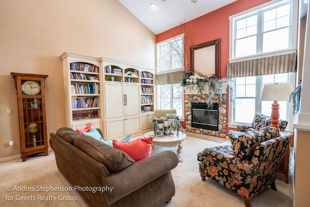 living area featuring a fireplace, high vaulted ceiling, and light colored carpet