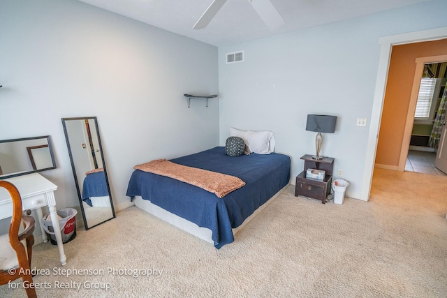 bedroom featuring carpet floors, visible vents, and a ceiling fan