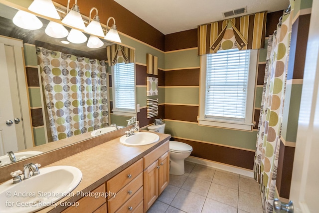 full bathroom with tile patterned flooring, visible vents, a sink, and double vanity