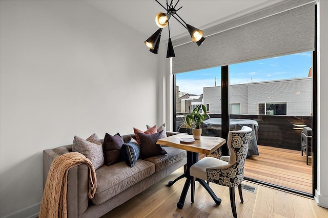 dining area with visible vents and wood finished floors