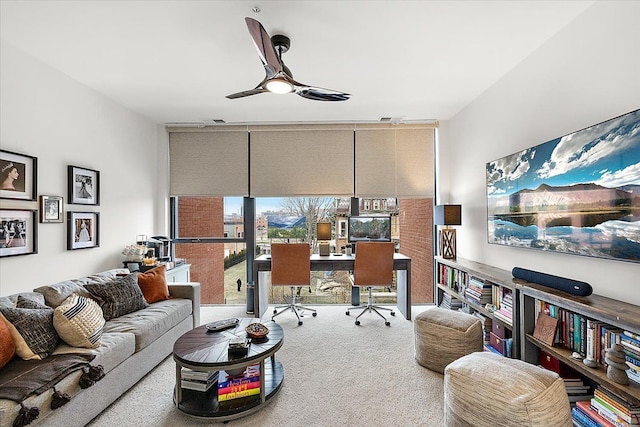office area featuring a wall of windows, ceiling fan, visible vents, and carpet floors