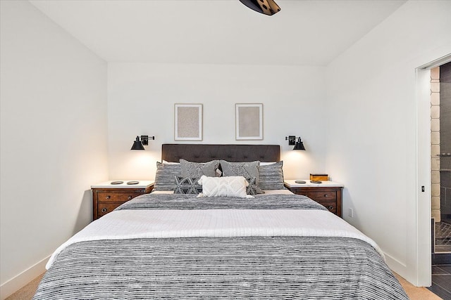 bedroom with baseboards and light colored carpet