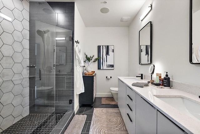 bathroom with double vanity, a sink, and a stall shower