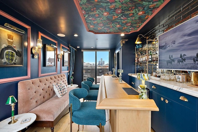 bar featuring wood finished floors and bar area