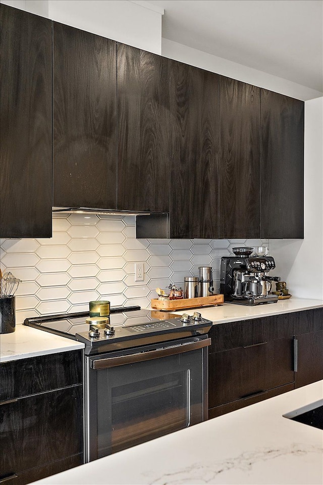 kitchen with modern cabinets, black range with electric cooktop, and tasteful backsplash