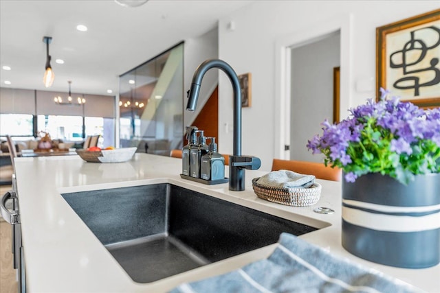 room details featuring a sink, a chandelier, and recessed lighting