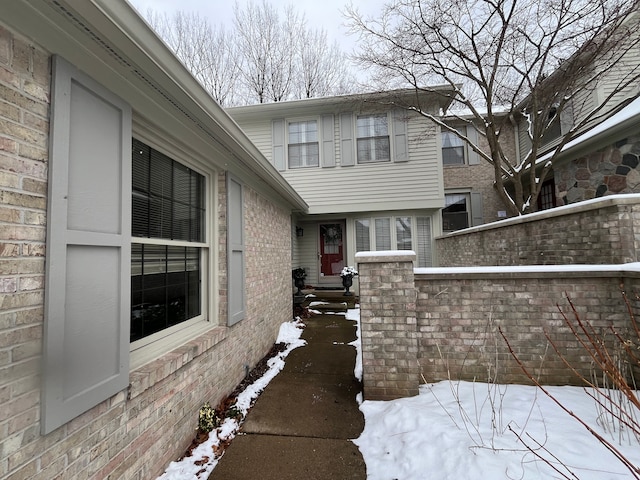 view of snow covered property entrance