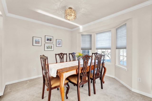 carpeted dining room featuring an inviting chandelier and crown molding