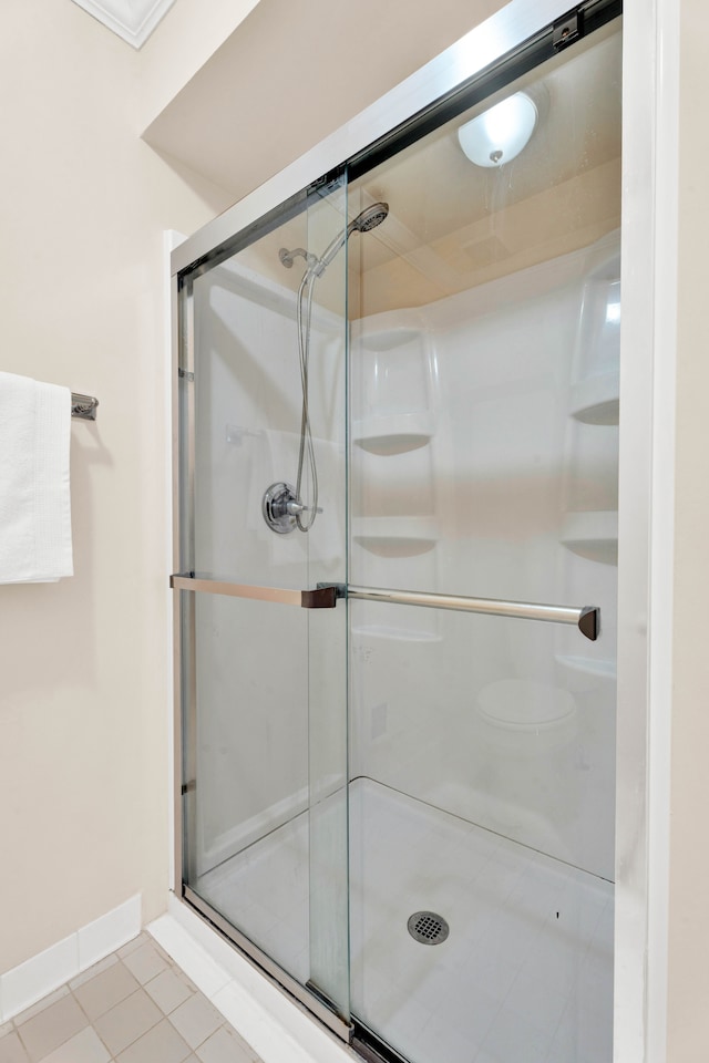 bathroom featuring tile patterned floors and a shower with shower door