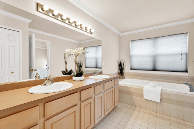 bathroom featuring tile patterned floors, crown molding, tiled tub, and vanity