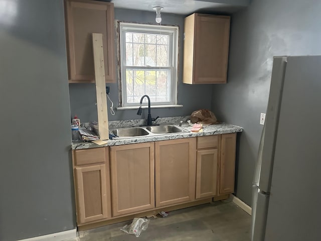 kitchen featuring sink and white fridge