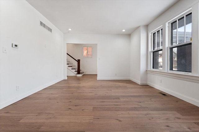 empty room with light hardwood / wood-style flooring