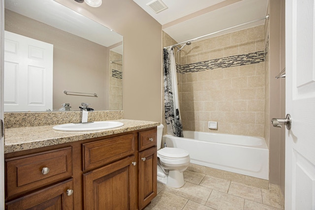 full bathroom featuring tile patterned floors, shower / tub combo with curtain, vanity, and toilet