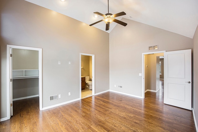 unfurnished bedroom featuring a closet, ceiling fan, high vaulted ceiling, a walk in closet, and ensuite bathroom