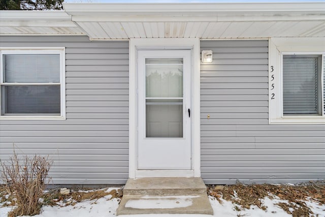 view of snow covered property entrance