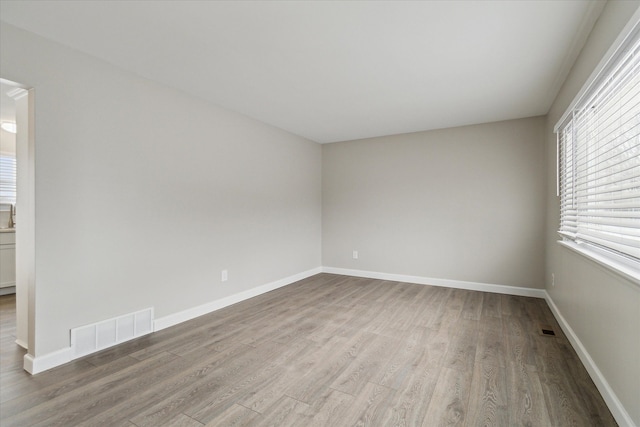 spare room featuring light hardwood / wood-style floors