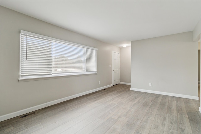 spare room with light wood-type flooring