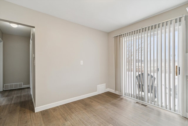 empty room with wood-type flooring