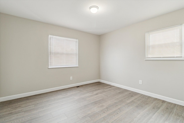 spare room with a healthy amount of sunlight and light wood-type flooring