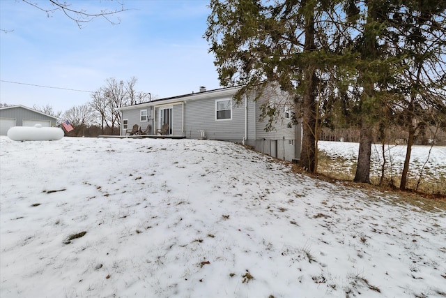 view of snow covered rear of property