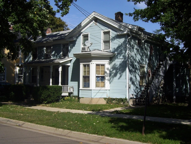 view of front of home with covered porch and a front yard