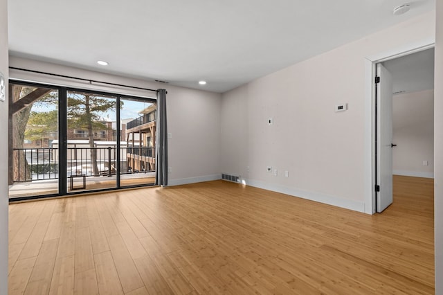 empty room with light hardwood / wood-style flooring