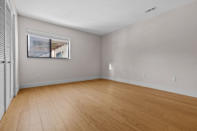 spare room featuring light hardwood / wood-style floors