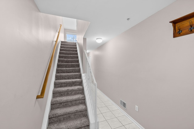 staircase with tile patterned flooring