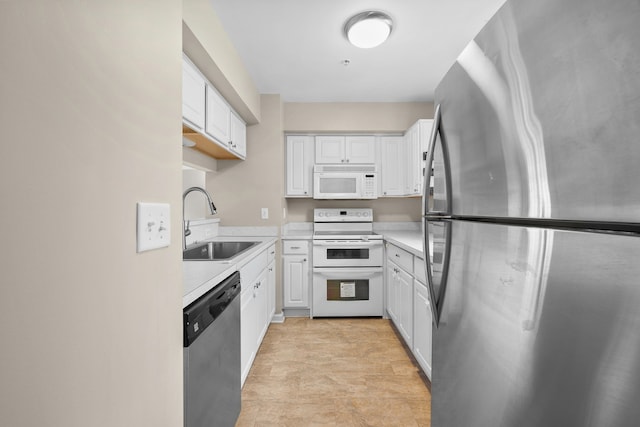 kitchen featuring white cabinets, sink, and appliances with stainless steel finishes