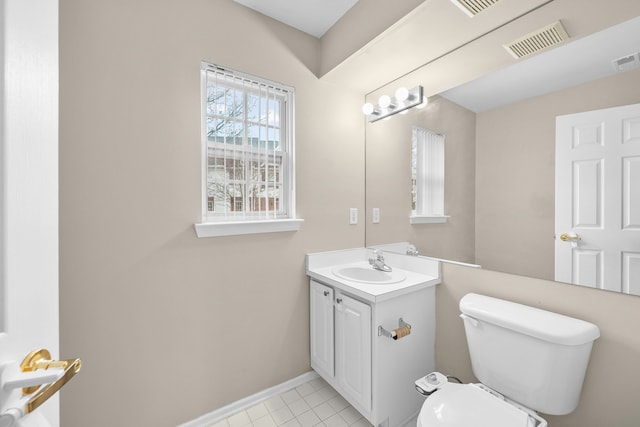 bathroom with tile patterned flooring, vanity, and toilet