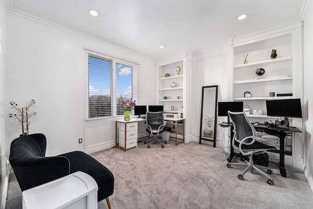 carpeted office with built in features and crown molding