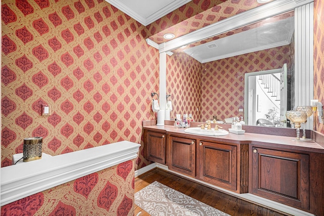 bathroom featuring crown molding, vanity, and hardwood / wood-style flooring