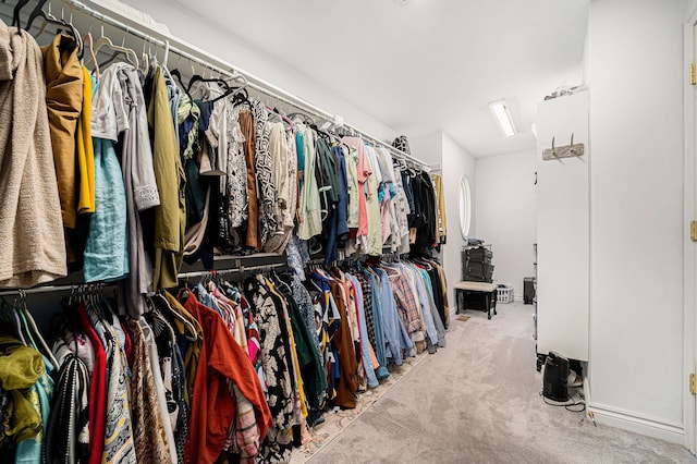 spacious closet featuring light carpet