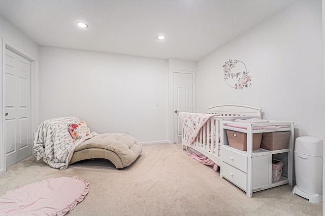 carpeted bedroom with a crib