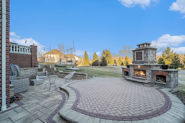 view of patio with an outdoor stone fireplace