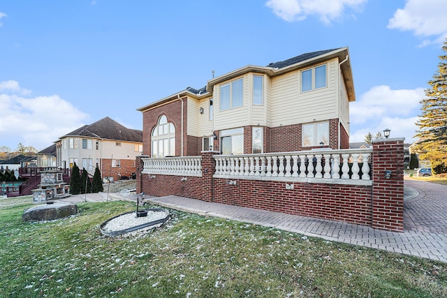 back of house with a lawn