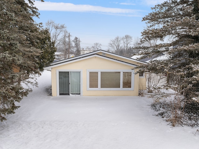 view of snow covered back of property