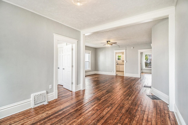 spare room featuring a textured ceiling, ceiling fan, and dark wood-type flooring