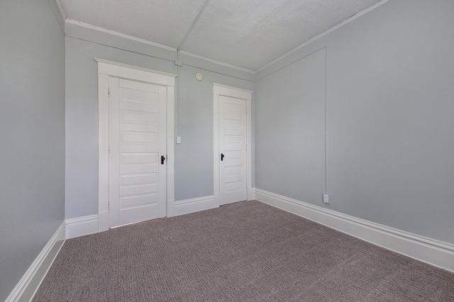 unfurnished bedroom with crown molding, a closet, and carpet