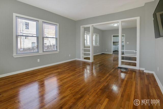 empty room with dark hardwood / wood-style floors