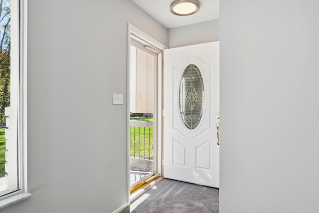 view of carpeted foyer entrance