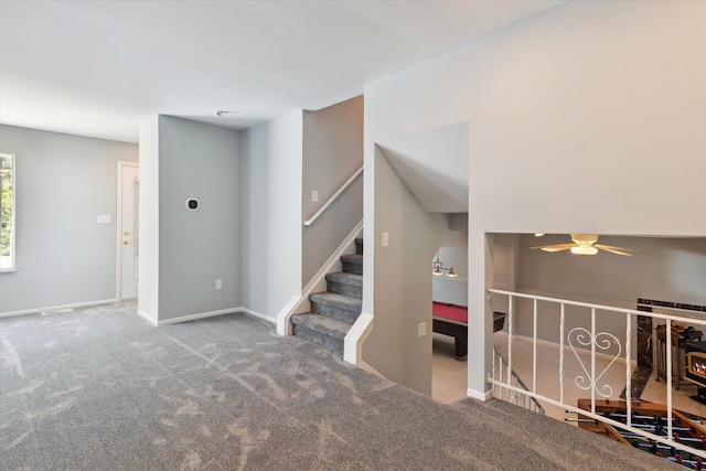 interior space featuring ceiling fan and carpet floors