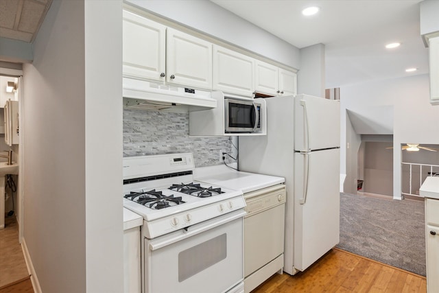 kitchen featuring tasteful backsplash, white cabinetry, ceiling fan, and white appliances