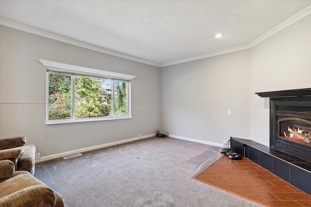 carpeted living room featuring ornamental molding and a tiled fireplace