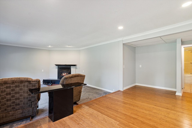 living room featuring hardwood / wood-style flooring and crown molding