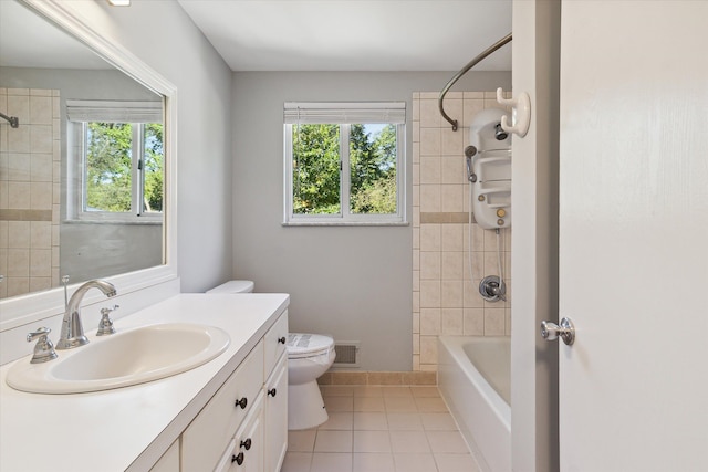 full bathroom with toilet, vanity, tile patterned floors, and tiled shower / bath combo