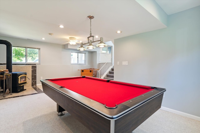 game room featuring carpet, plenty of natural light, a wood stove, and billiards