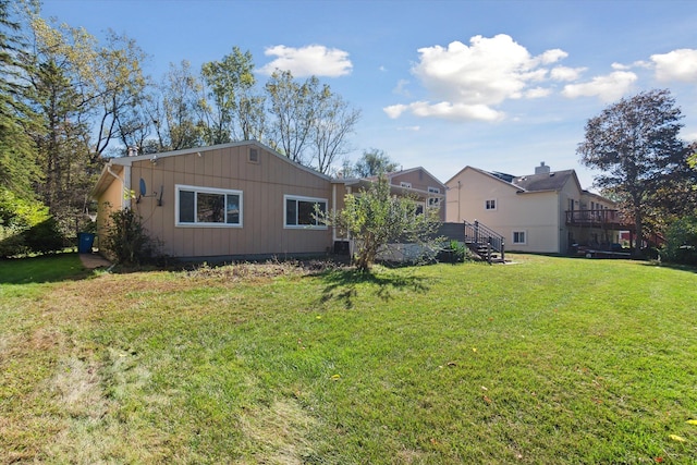 rear view of house featuring a lawn