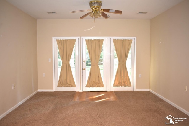 spare room featuring carpet and ceiling fan